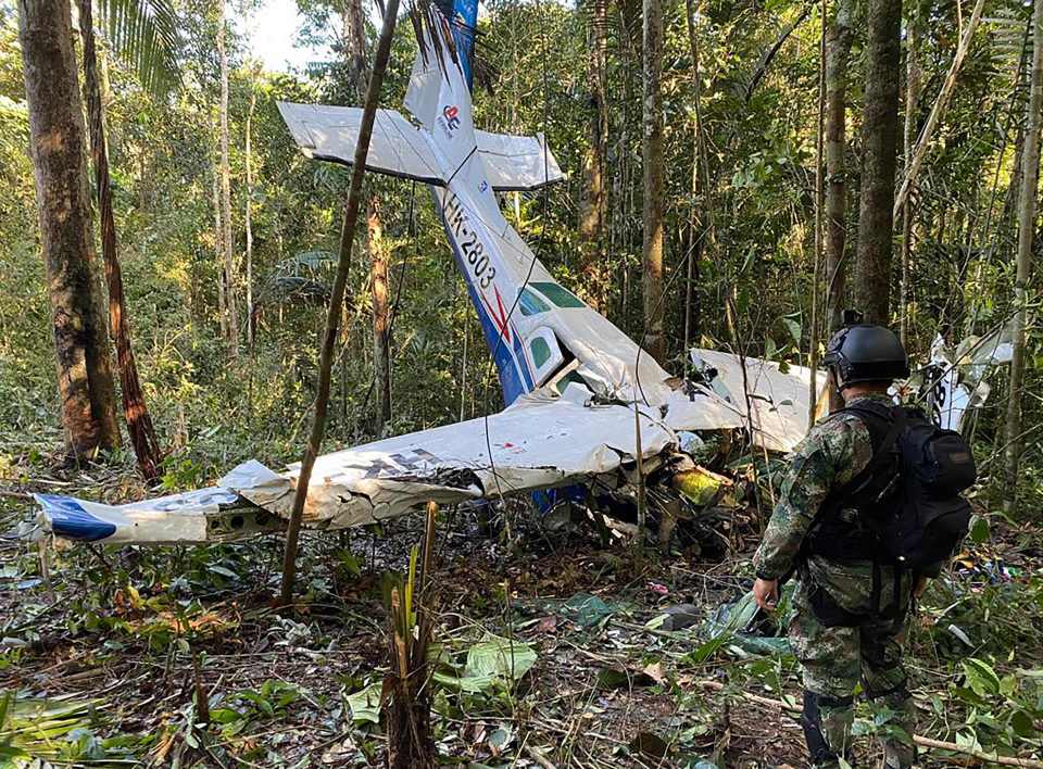 a soldier stands in front of a plane that has the numbers nk-2802 on it