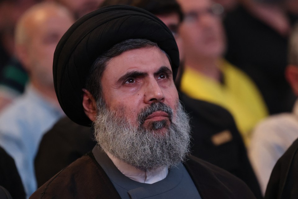 a man with a beard is wearing a black hat