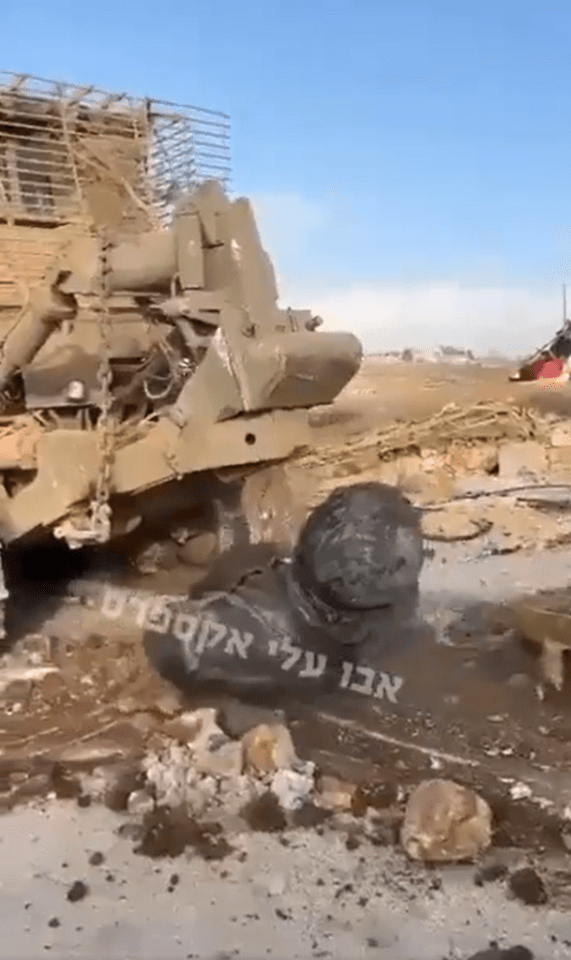 a broken military vehicle with hebrew writing on it