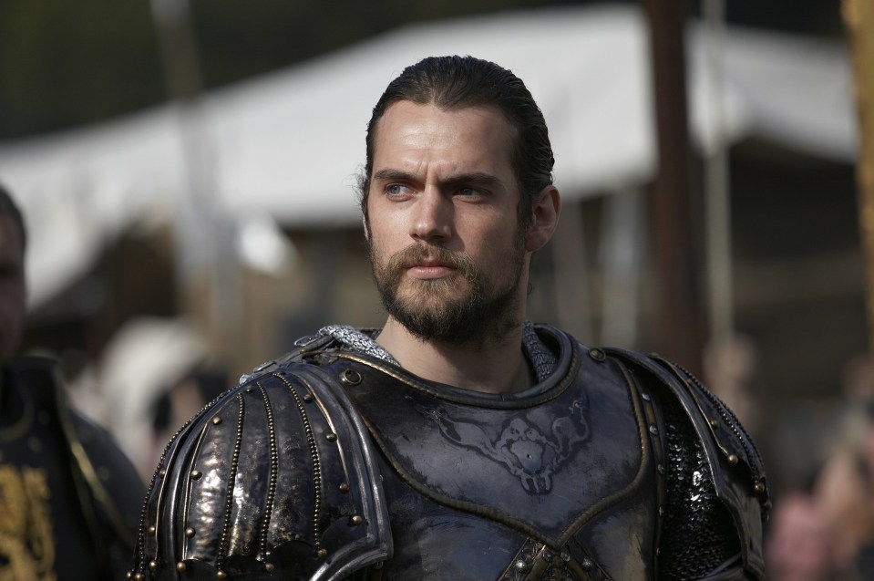 a man with a beard is wearing armor