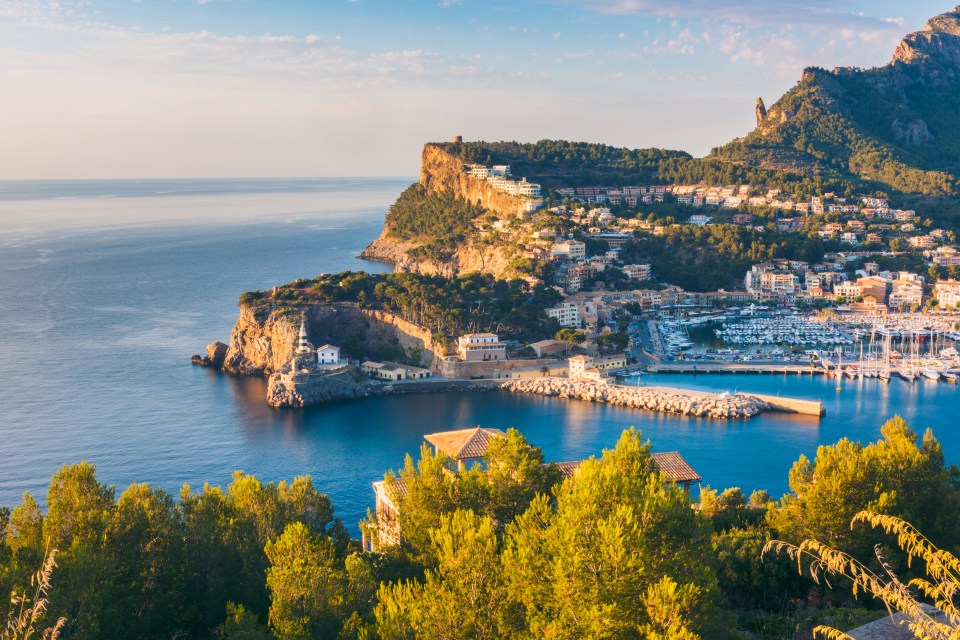 a small town sits on a cliff overlooking the ocean