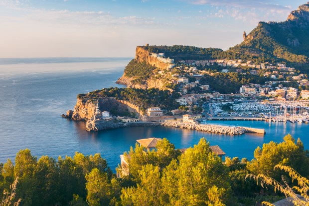 a small town sits on a cliff overlooking the ocean