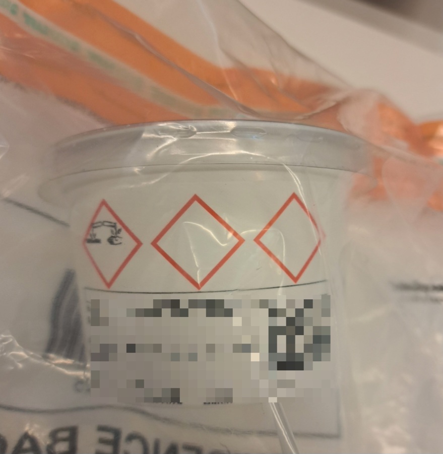 a plastic container with a warning label on it