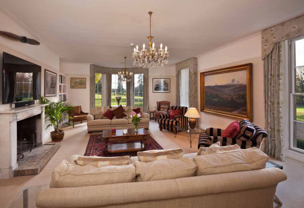 a living room filled with furniture and a chandelier