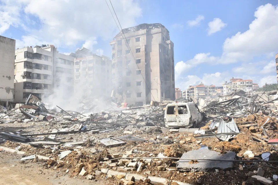 a white van is parked in the middle of a pile of rubble