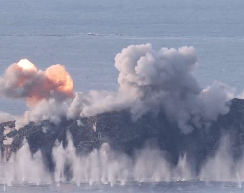 a large cloud of smoke is coming out of a volcano