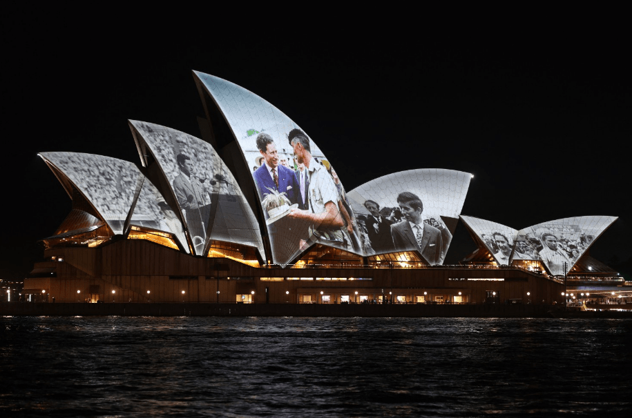 the sydney opera house is lit up at night