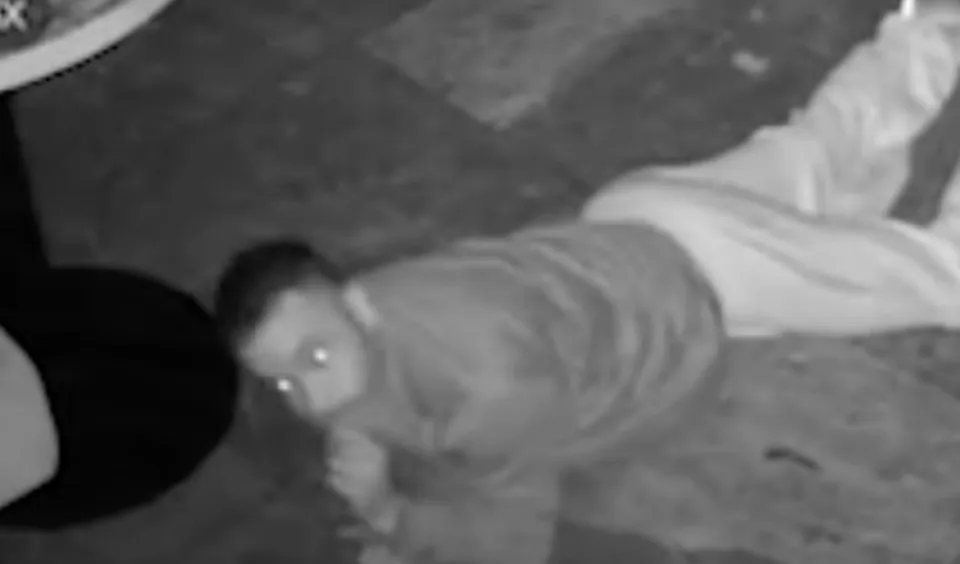 a man is laying on the ground in a black and white photo .