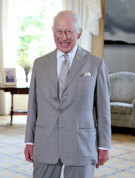 a man in a suit and tie smiles for the camera
