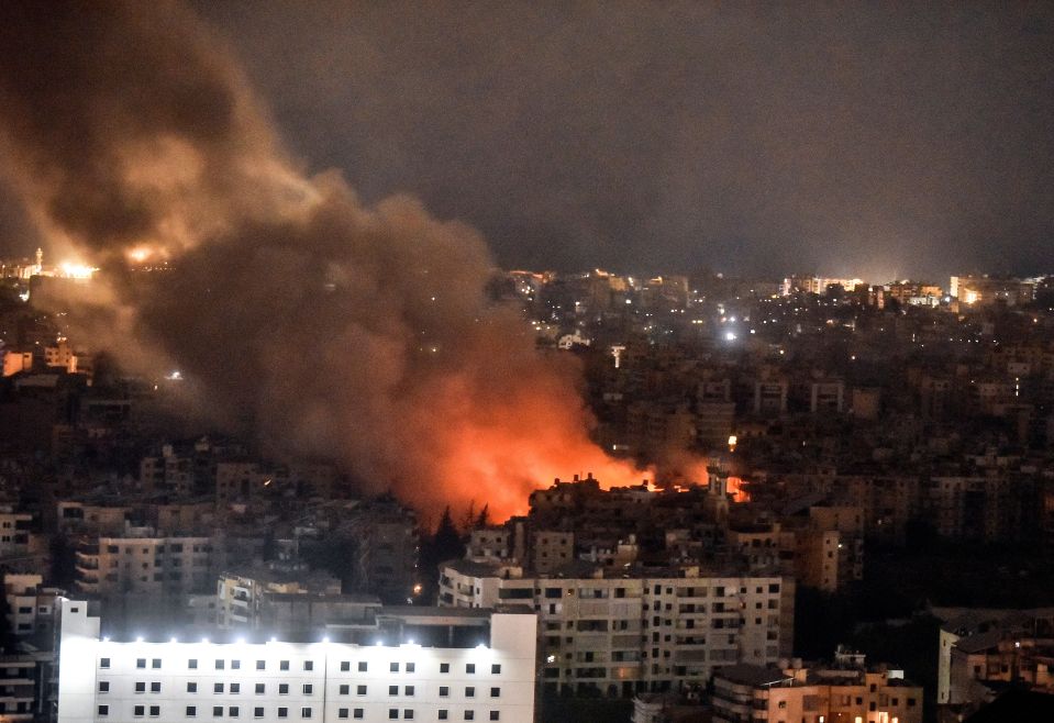 smoke coming out of a building in a city at night