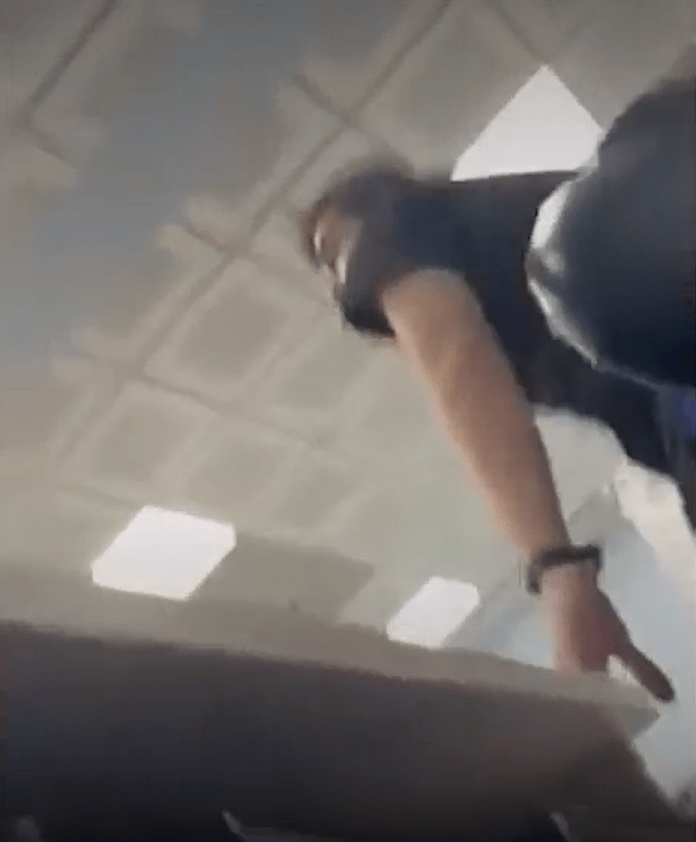a person is standing on a table in a room with a ceiling .