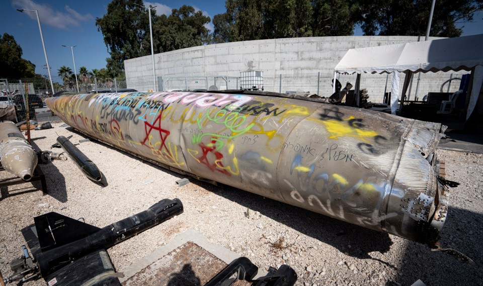 a large metal object has been covered in graffiti including the letters g and g.