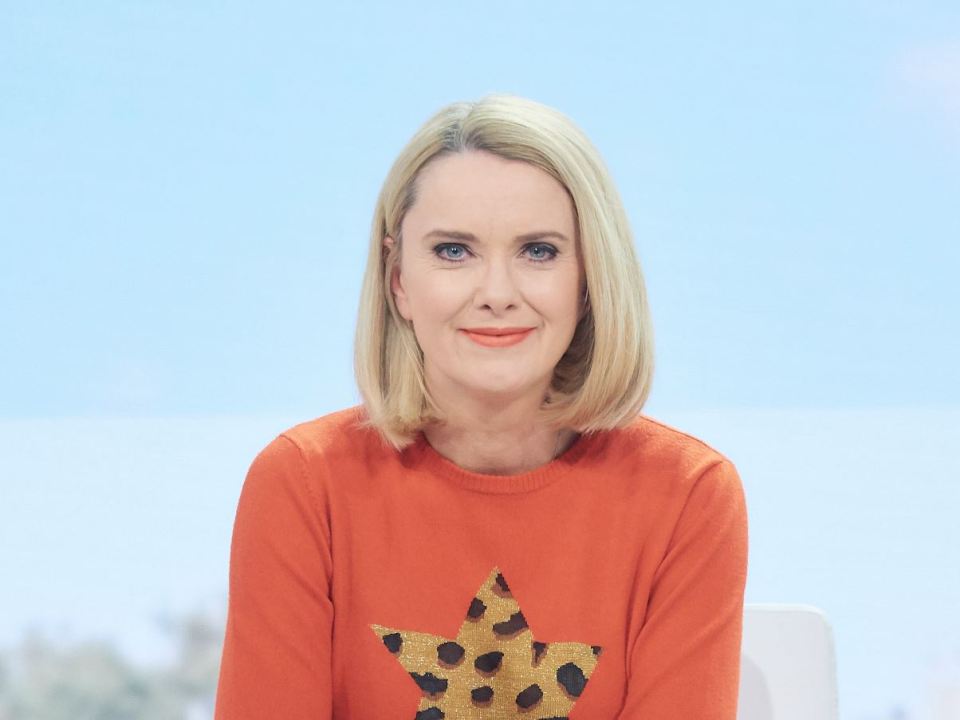 a woman wearing an orange sweater with a star on it