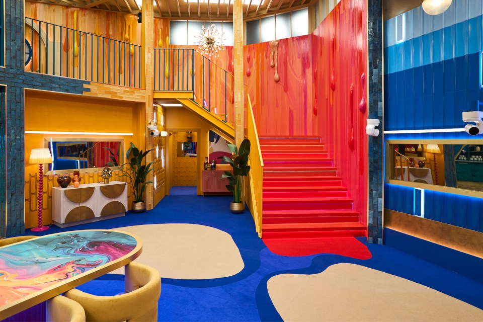 a colorful room with a red carpet and stairs