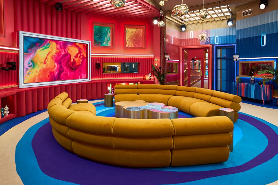 a colorful living room with a large yellow couch