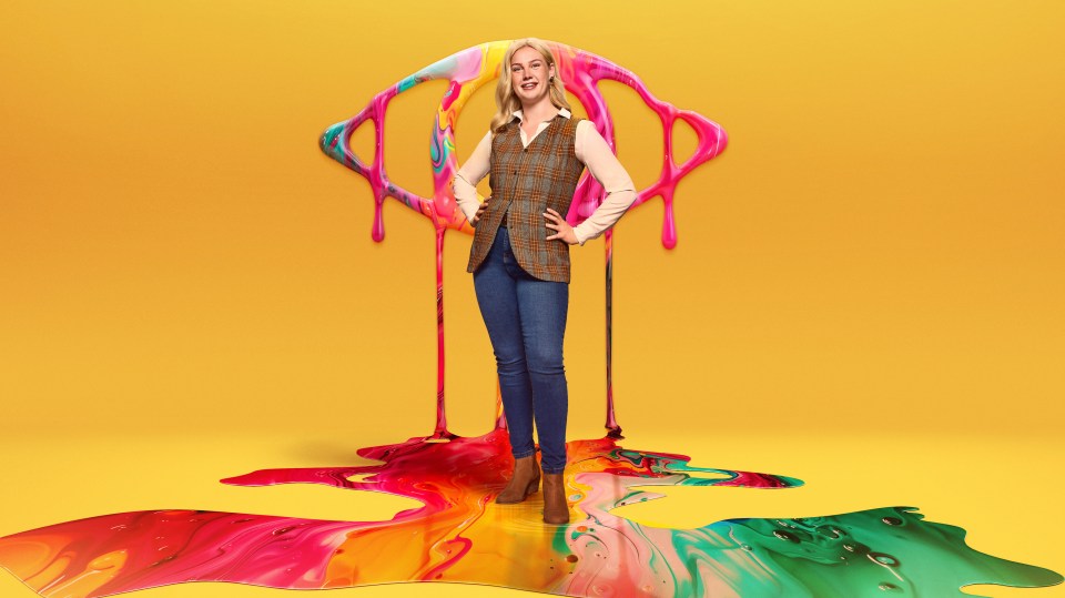 a woman is standing in front of a rainbow of paint