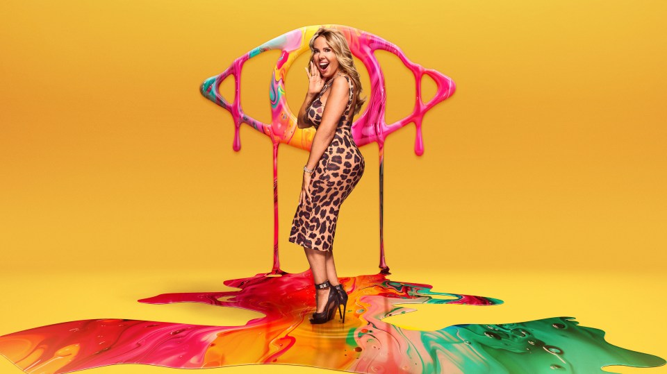 a woman in a leopard print dress stands in front of a colorful painting