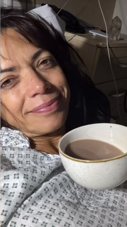 a woman in a hospital gown sits next to a bowl of coffee