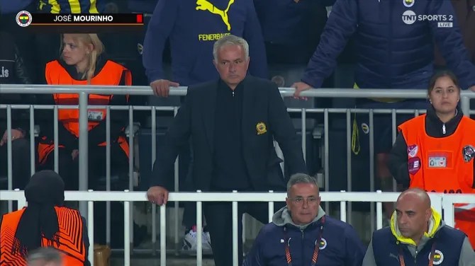 jose mourinho is sitting in the stands watching a soccer game