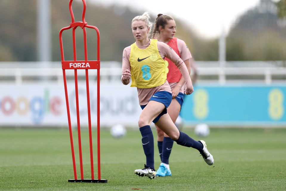 two female soccer players one wearing a nike vest