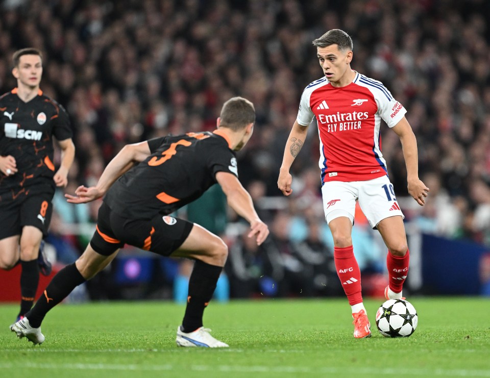 soccer player wearing a jersey that says emirates fly better