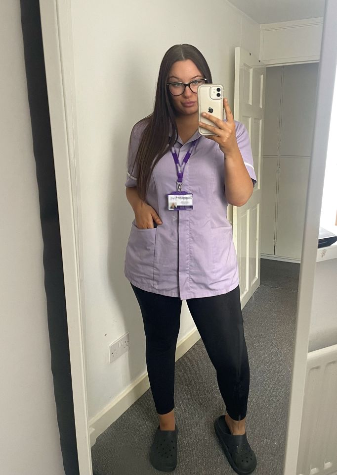 a nurse taking a selfie in front of a mirror