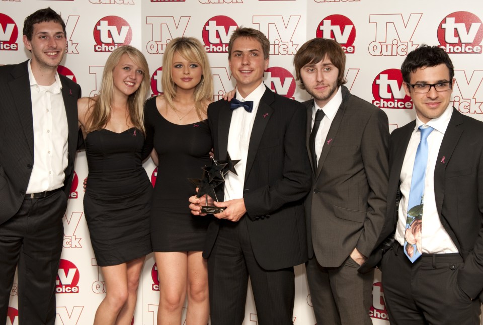 a group of people standing in front of a wall that says tv choice