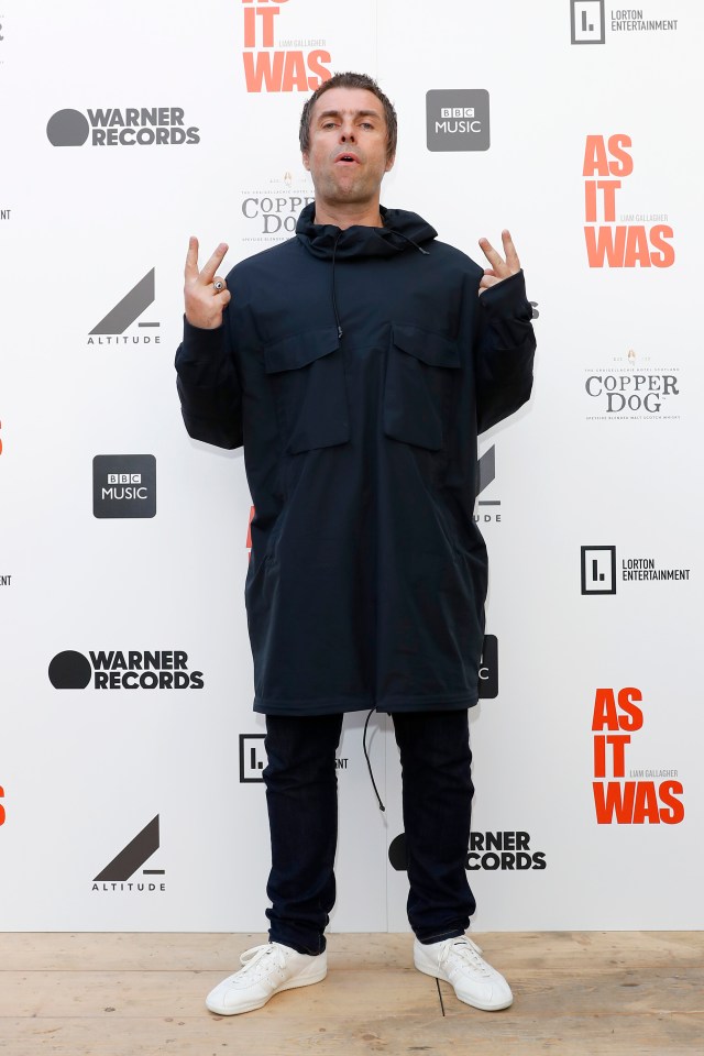 a man stands in front of a wall that says as it was