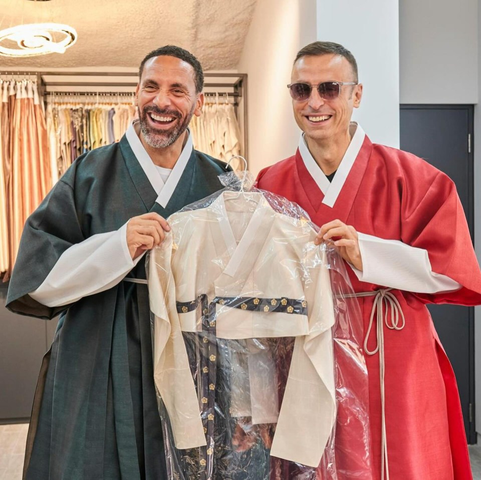 a man in a red robe is holding a white shirt