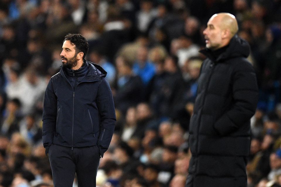 a man in a blue jacket stands next to a man in a black jacket