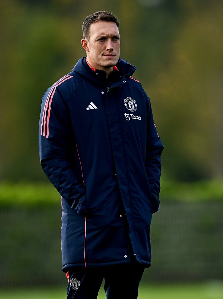 a man wearing a jacket that says manchester united on it