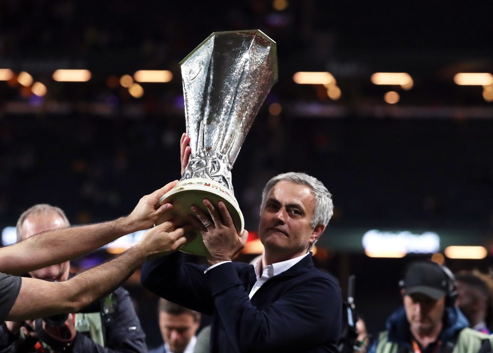 a man holding a trophy that says ' uefa champions league ' on it