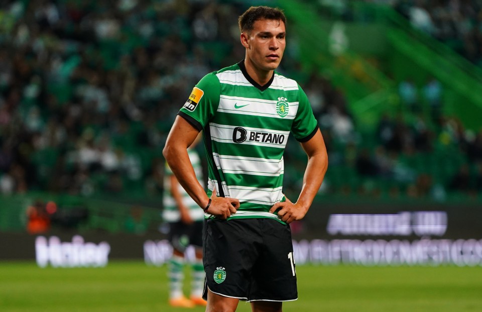 a soccer player wearing a betano jersey stands on the field