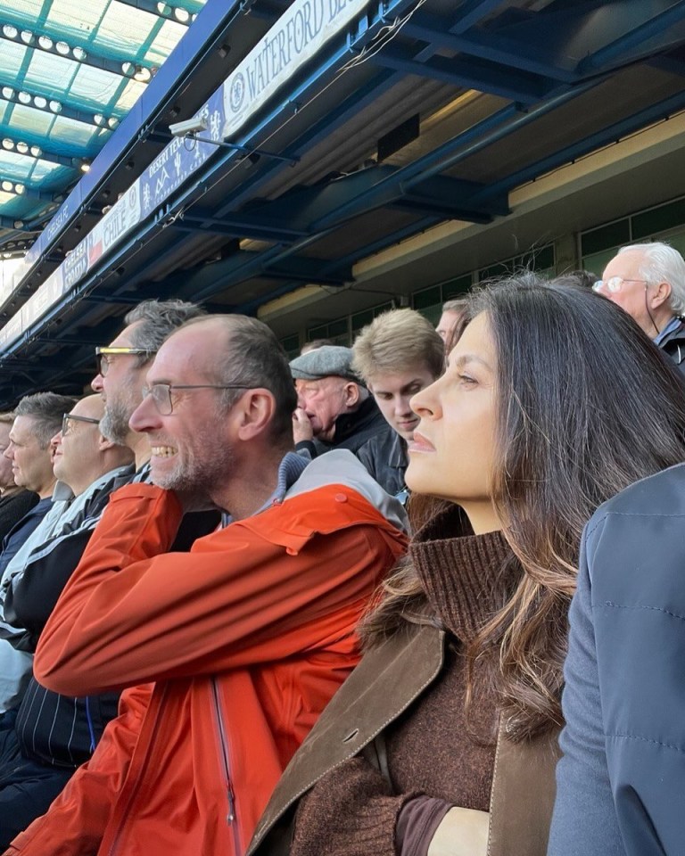 a group of people sitting in a stadium with a sign that says waterford