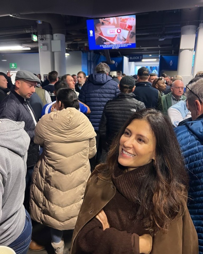 a woman stands in a crowd in front of a screen that says block 2