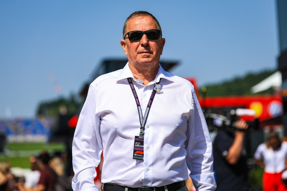 a man wearing sunglasses and a lanyard that says ' ferrari ' on it