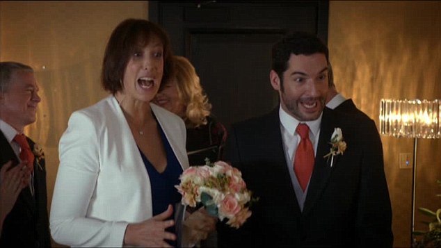 a bride and groom are walking down the aisle and the bride is holding a bouquet of flowers