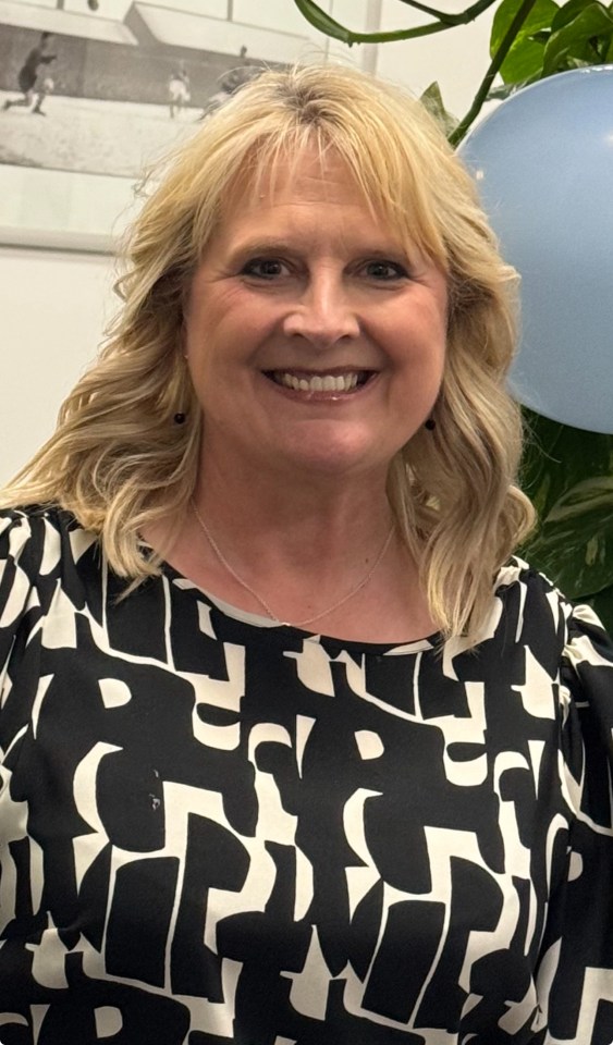 a woman wearing a black and white shirt with the letter p on it
