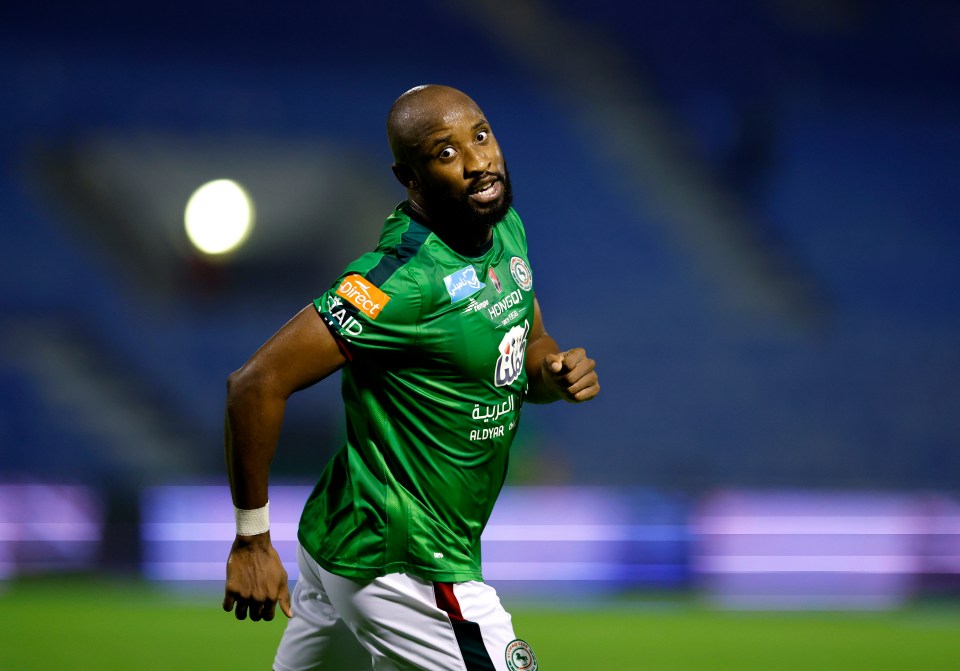 a soccer player wearing a green shirt that says vaio on it