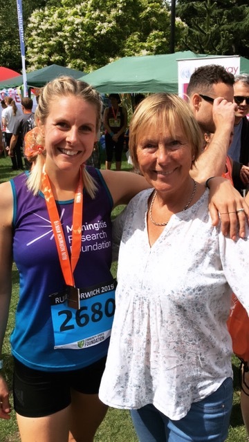 two women posing for a picture with one wearing a shirt that says meningitis research foundation