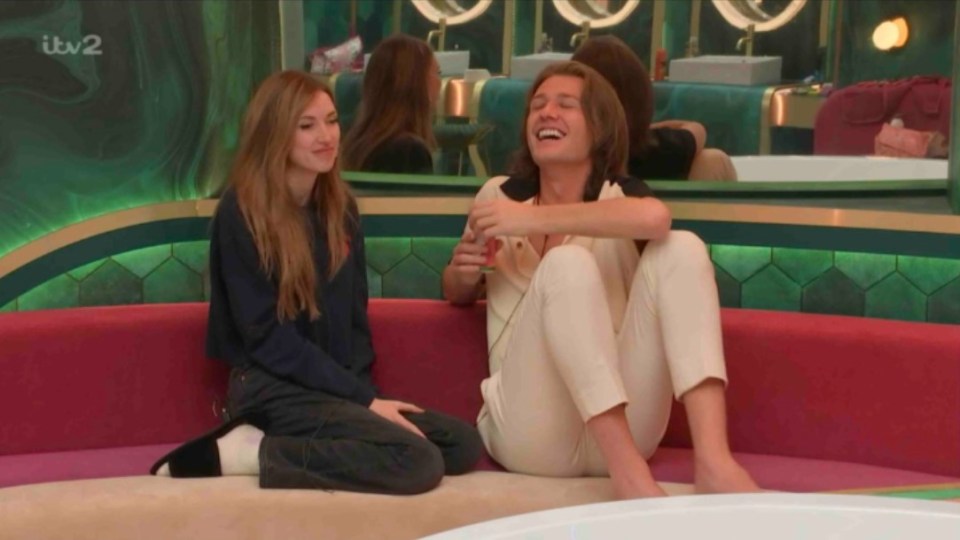 a man and a woman sit on a couch with itv2 written on the bottom