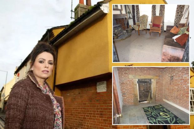 a woman is standing in front of a yellow building