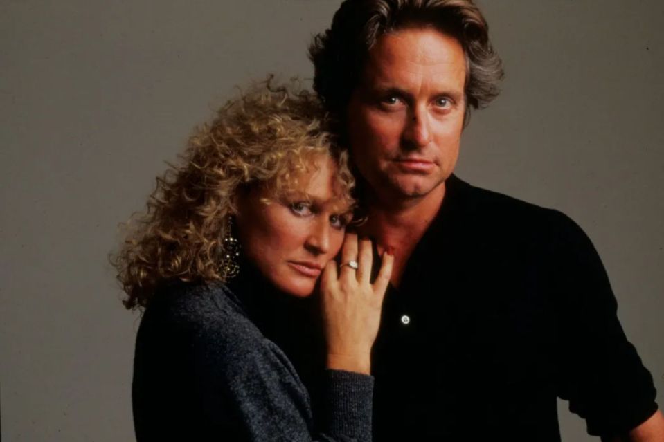 a man and a woman are posing for a picture and the woman has a ring on her finger
