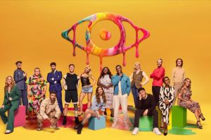 a group of people standing in front of a colorful eye