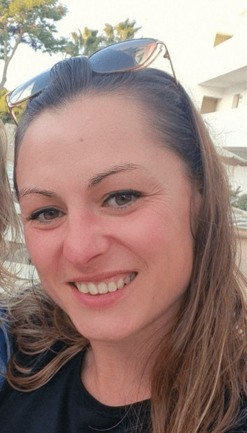 a woman wearing sunglasses smiles for the camera
