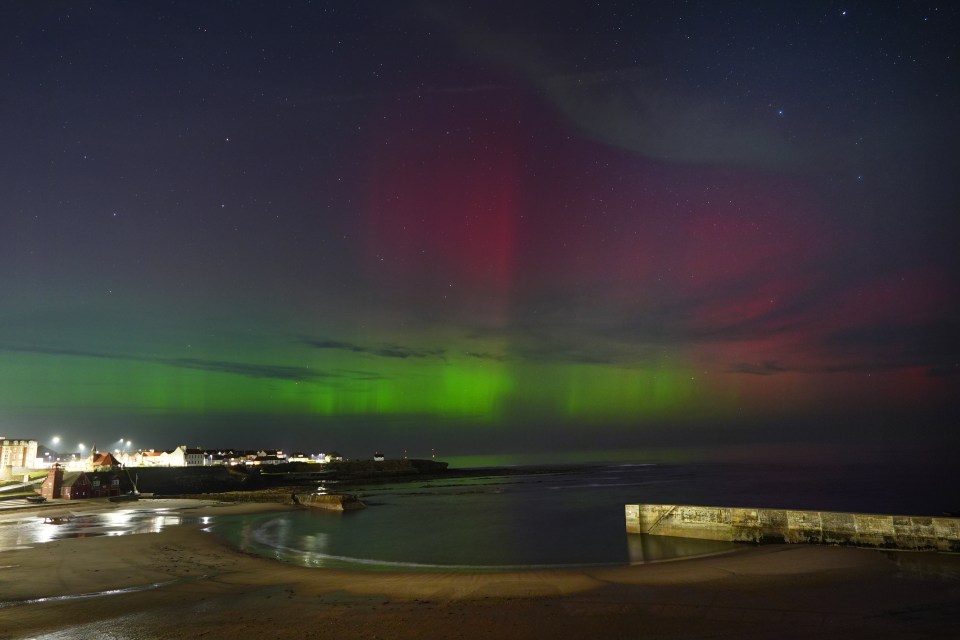 the aurora borealis shines brightly over the ocean