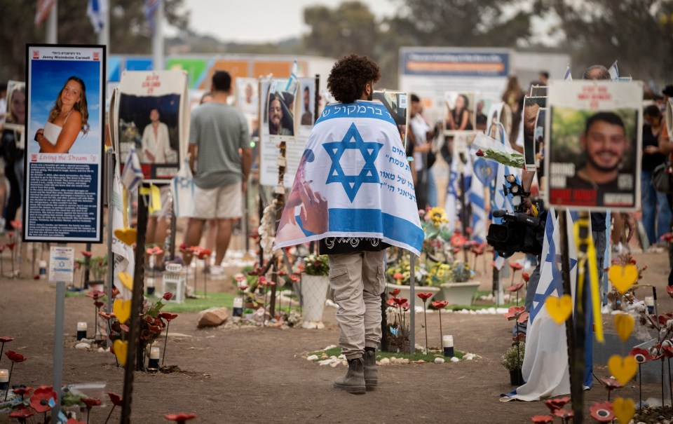 a man holding a flag with a star of david on it
