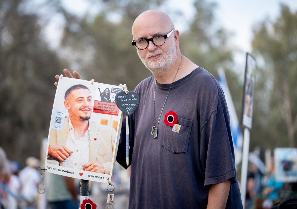 a man holds up a picture of a man with the name aaron on it