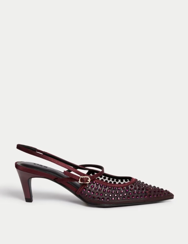 a pair of burgundy slingback shoes with studs on them