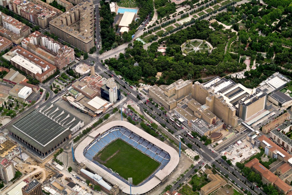 an aerial view of a city with a stadium in the middle